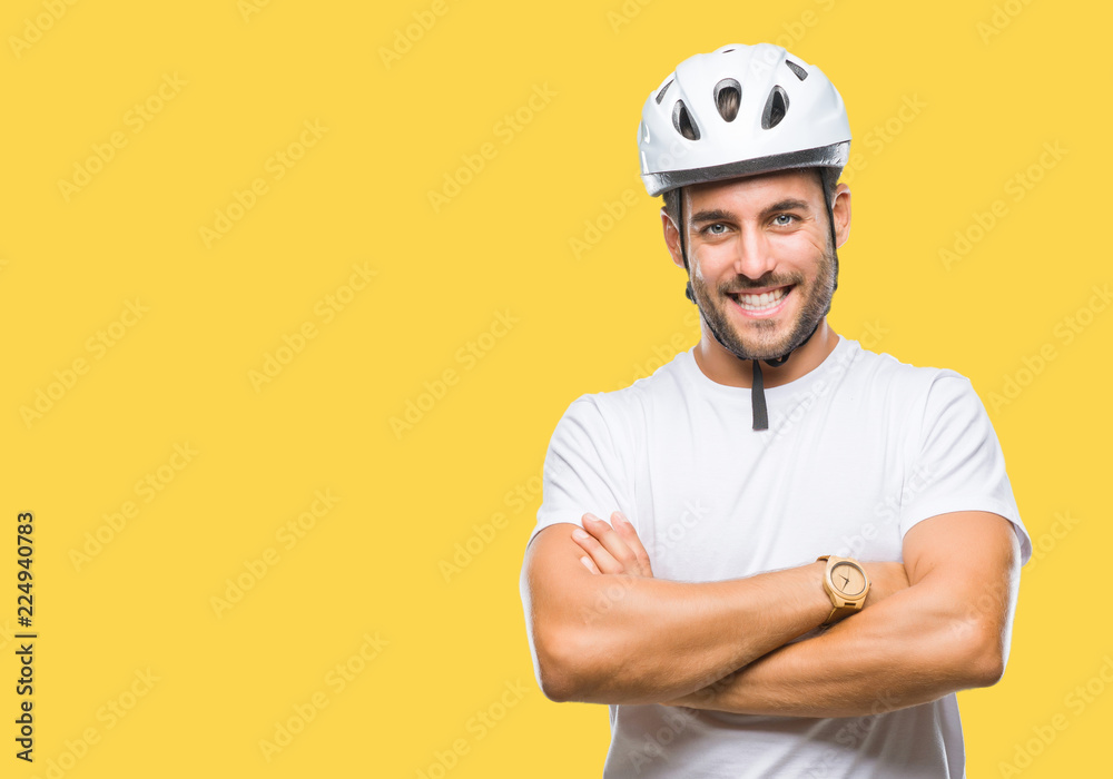 Young handsome man wearing cyclist safety helmet over isolated background happy face smiling with crossed arms looking at the camera. Positive person.