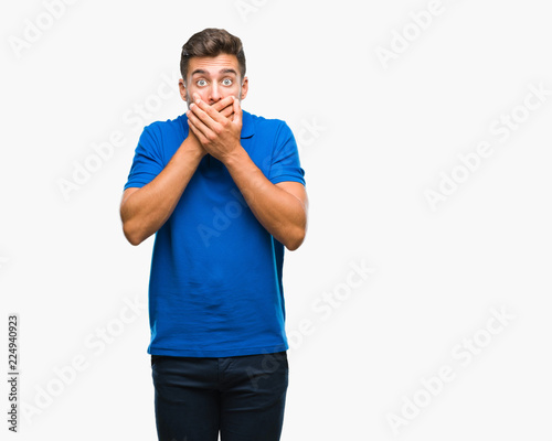Young handsome man over isolated background shocked covering mouth with hands for mistake. Secret concept.