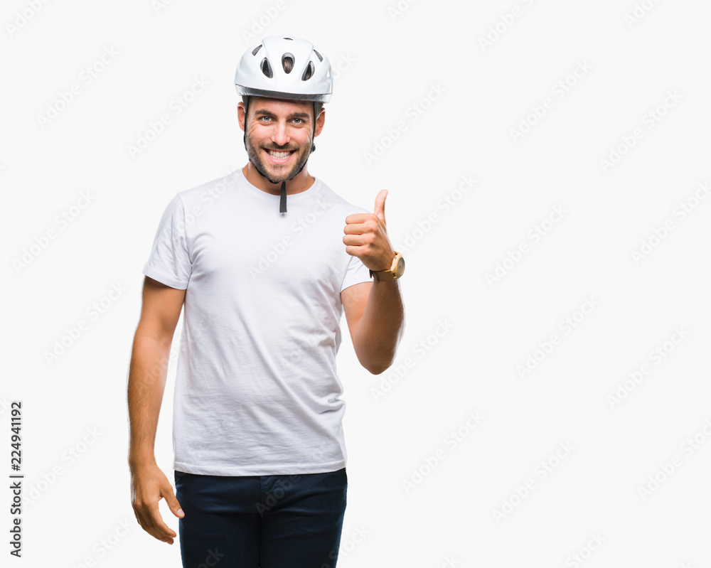 Young handsome man wearing cyclist safety helmet over isolated background doing happy thumbs up gesture with hand. Approving expression looking at the camera with showing success. Young handsome man wearing cyclist safety helmet over isolated background doing happy thumbs up gesture with hand. Approving expression looking at the camera with showing success.