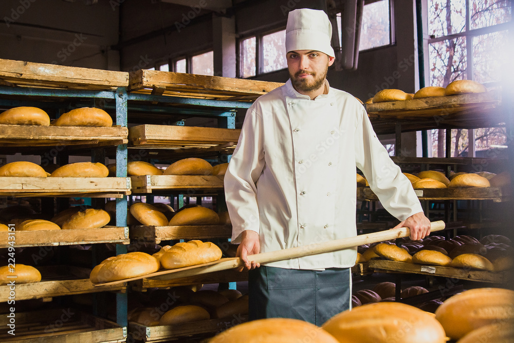 professional bread baker in bakery shop and posing with shelf with uncooked  raw bread knead on shovel. concept of traditional manual bread preparation  Stock Photo - Alamy