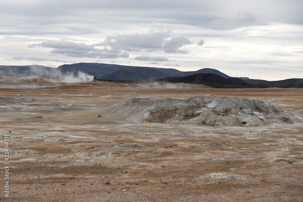Geothermal area of Hverir in Iceland with people and steam. Geothermal area of Hverir in Iceland with people and steam.