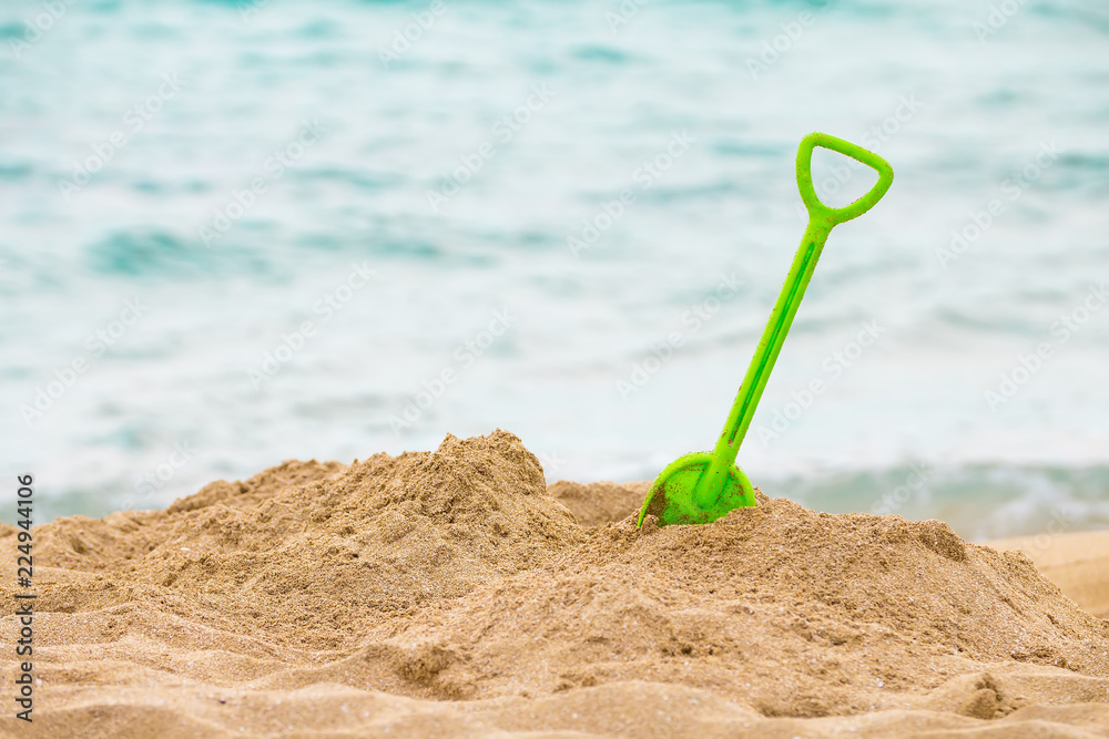 Children scoop, soave waves in the sea and sand on the beach, autumn mood, end of vacation Children scoop, soave waves in the sea and sand on the beach, autumn mood, end of vacation