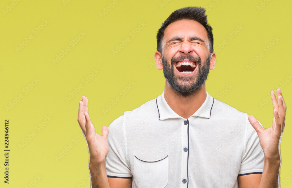 Adult hispanic man over isolated background celebrating mad and crazy for success with arms raised and closed eyes screaming excited. Winner concept Adult hispanic man over isolated background celebrating mad and crazy for success with arms raised and closed eyes screaming excited. Winner concept