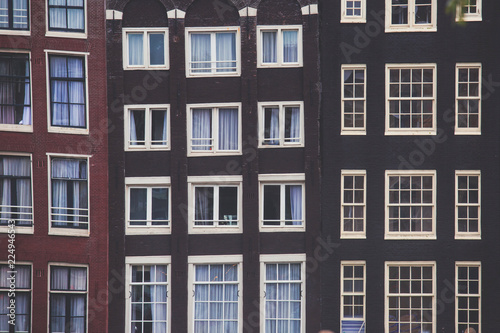 Summer view of the "Dancing Canal Houses of Damrak' , iconic canal houses in the capital city of Amsterdam, Netherlands