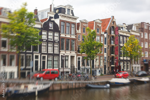 Summer view of the "Dancing Canal Houses of Damrak' , iconic canal houses in the capital city of Amsterdam, Netherlands