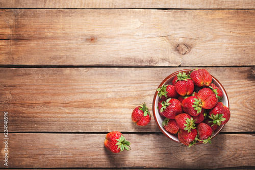 strawberries on a plate on wooden table