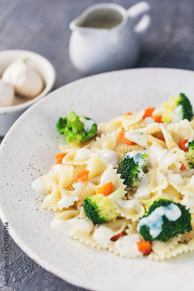 Homemade farfalle with with broccoli and carrots, bechamel Homemade farfalle with with broccoli and carrots, bechamel