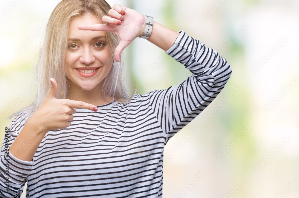 Young blonde woman over isolated background smiling making frame with hands and fingers with happy face. Creativity and photography concept. Young blonde woman over isolated background smiling making frame with hands and fingers with happy face. Creativity and photography concept.