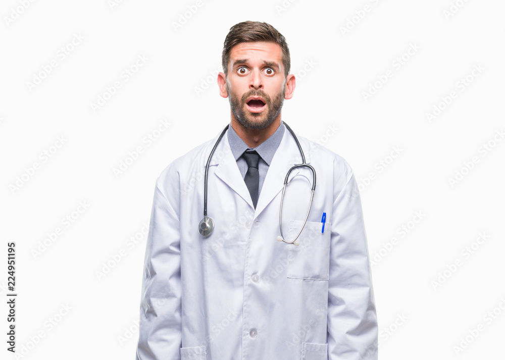 Young handsome doctor man over isolated background afraid and shocked with surprise expression, fear and excited face. Young handsome doctor man over isolated background afraid and shocked with surprise expression, fear and excited face.
