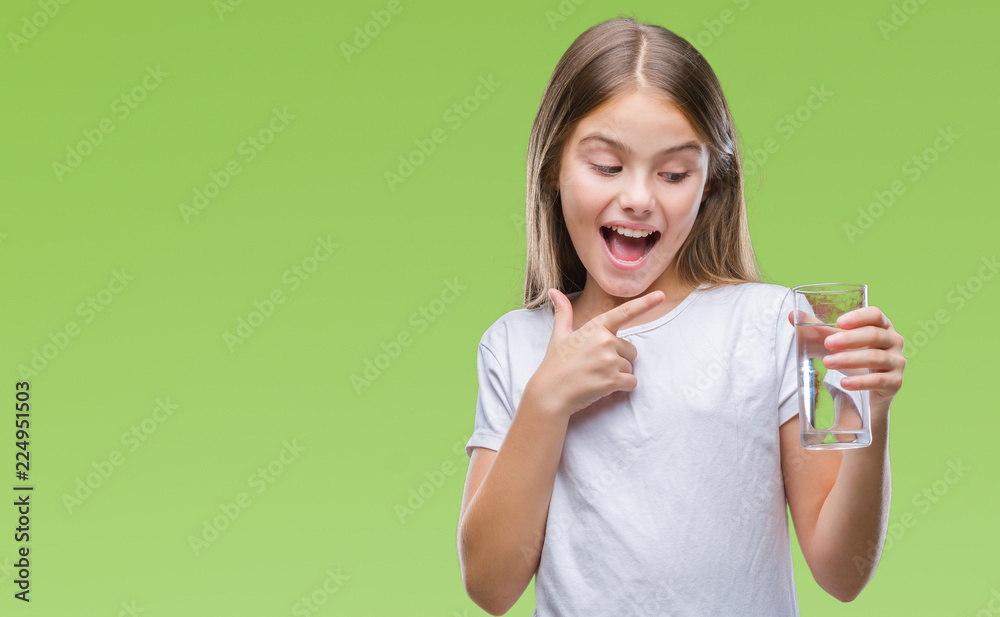 Young beautiful girl drinking glass of water over isolated background very happy pointing with hand and finger Young beautiful girl drinking glass of water over isolated background very happy pointing with hand and finger