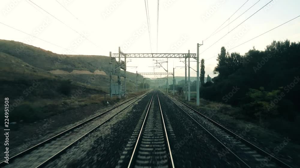 Travelling by passenger train in the morning, view from the rear of train Travelling by passenger train in the morning, view from the rear of train