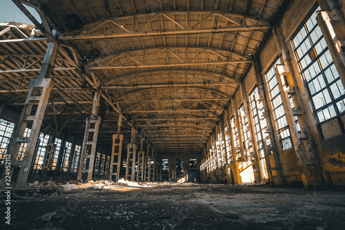 Abandoned and haunted industrial creepy warehouse inside, old ruined grunge factory building