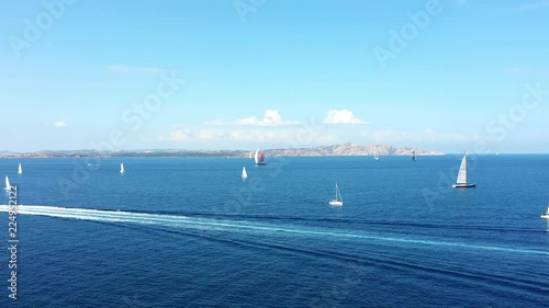 Video from above, aerial view of some yachts and sailing vessels douring a Regatta. September 2018, Sardinia, Italy. photo