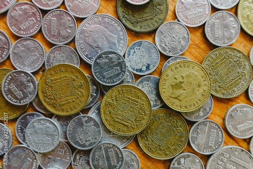 Group of old Spanish coins on wooden floor. photo