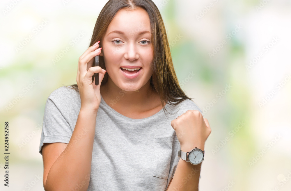 Young beautiful caucasian woman talking on smartphone over isolated background screaming proud and celebrating victory and success very excited, cheering emotion Young beautiful caucasian woman talking on smartphone over isolated background screaming proud and celebrating victory and success very excited, cheering emotion
