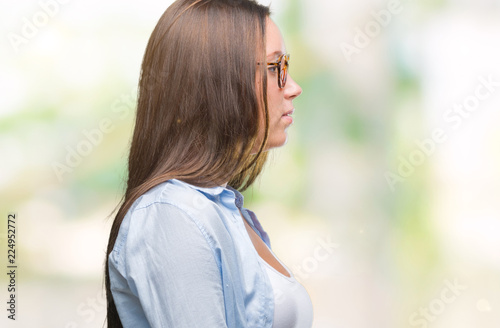 Young caucasian beautiful business woman wearing glasses over isolated background looking to side, relax profile pose with natural face with confident smile.