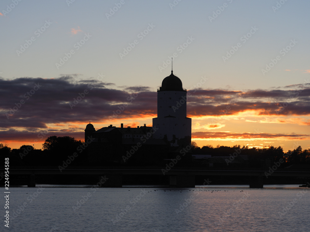 Silhouette Saint Olav tower, medieval Swedish fortress castle on the sunset background in Vyborg, Russia. The first record of the castle dates back to 1293