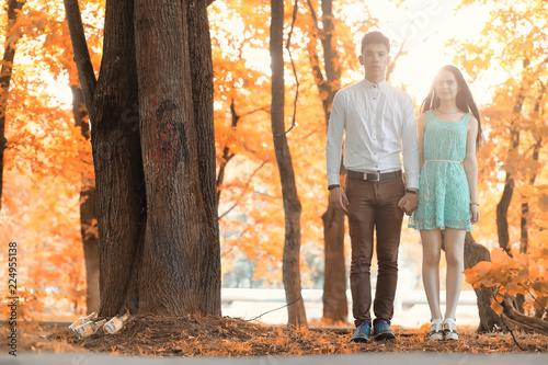 Young couple on a walk in autumn park 