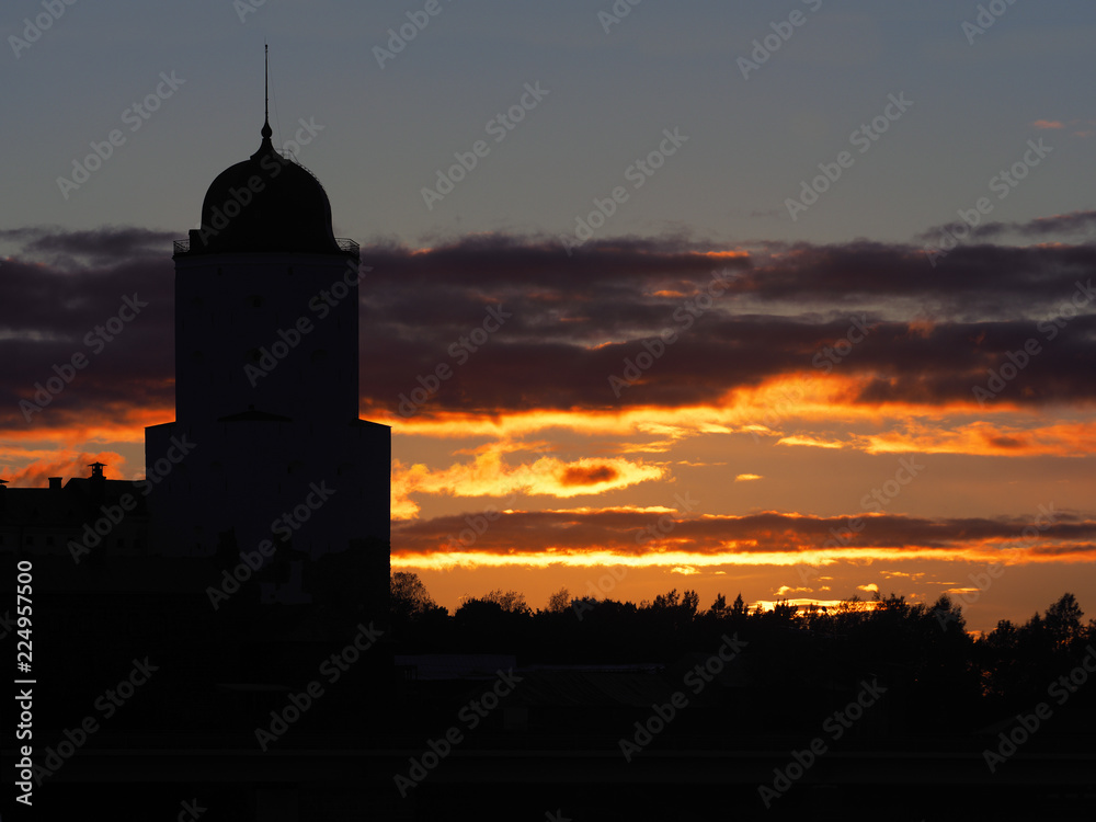 Silhouette Saint Olav tower, medieval Swedish fortress castle on the sunset background in Vyborg, Russia