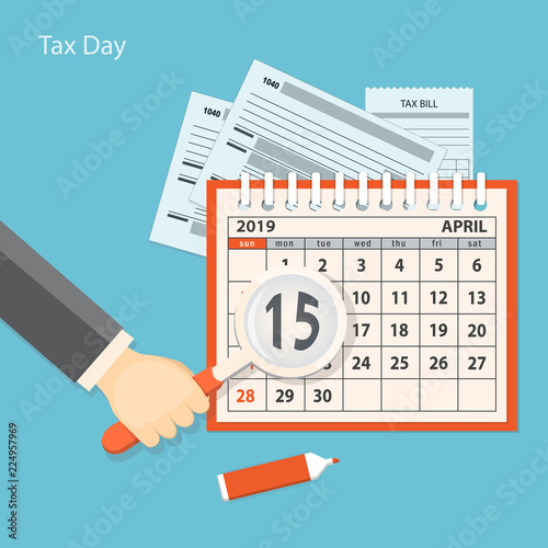 Tax day with human hand keeping the magnifier