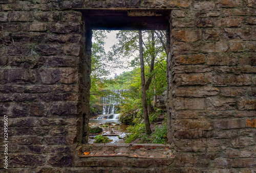 Fototapeta Naklejka Na Ścianę i Meble -  Historic stone mill window framing waterfall