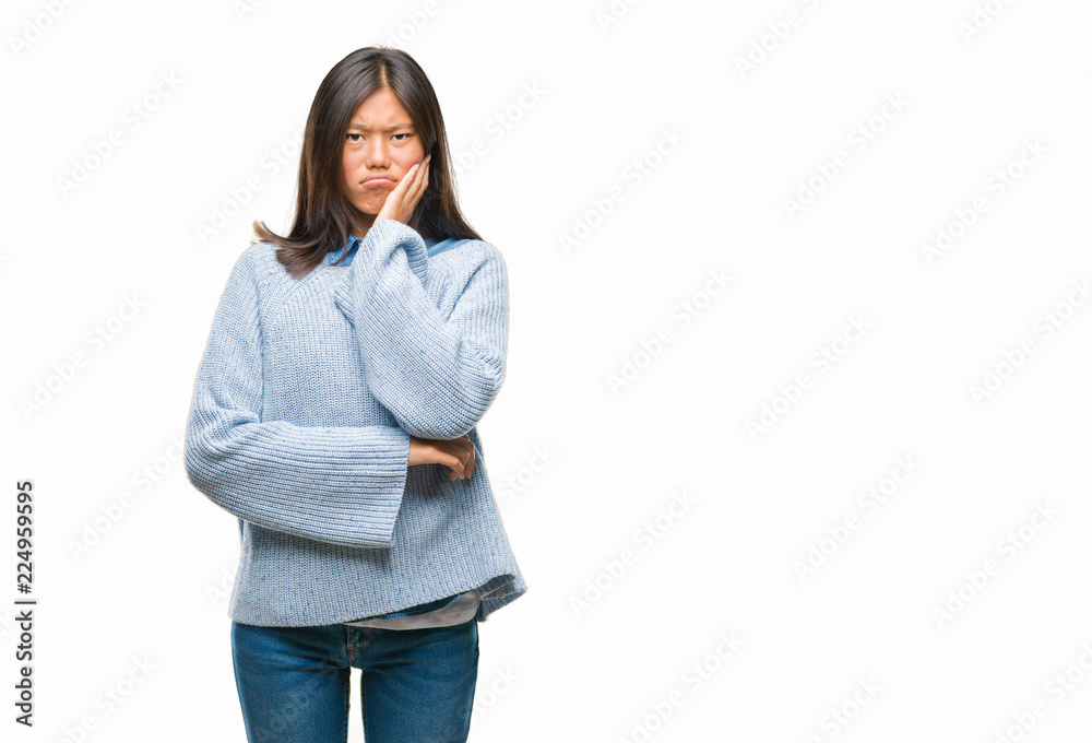 Young asian woman wearing winter sweater over isolated background thinking looking tired and bored with depression problems with crossed arms. Young asian woman wearing winter sweater over isolated background thinking looking tired and bored with depression problems with crossed arms.