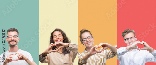 Collage of a group of people isolated over colorful background smiling in love showing heart symbol and shape with hands. Romantic concept. photo