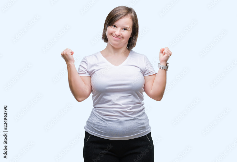 Young adult woman with down syndrome over isolated background very happy and excited doing winner gesture with arms raised, smiling and screaming for success. Celebration concept. Young adult woman with down syndrome over isolated background very happy and excited doing winner gesture with arms raised, smiling and screaming for success. Celebration concept.