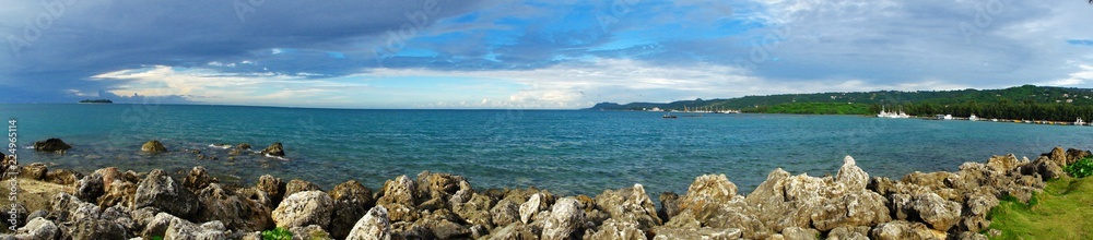 A panoramic view of the Smiling Cove Marina with distant views of Managaha Island on the left, and Saipan seaport on the right side