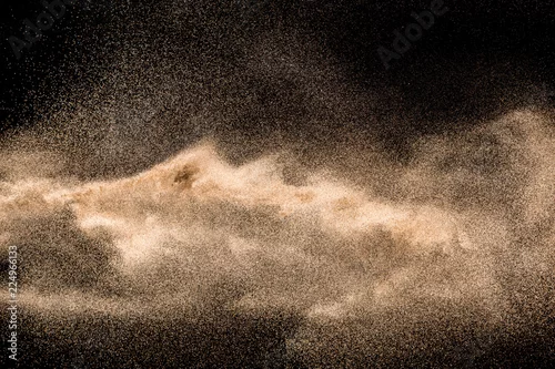 Obraz Dry river sand explosion. Golden colored sand splash against  black background.