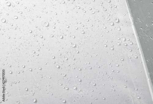 Water drops on waterproof fabric background. Raindrops on white umbrella. photo