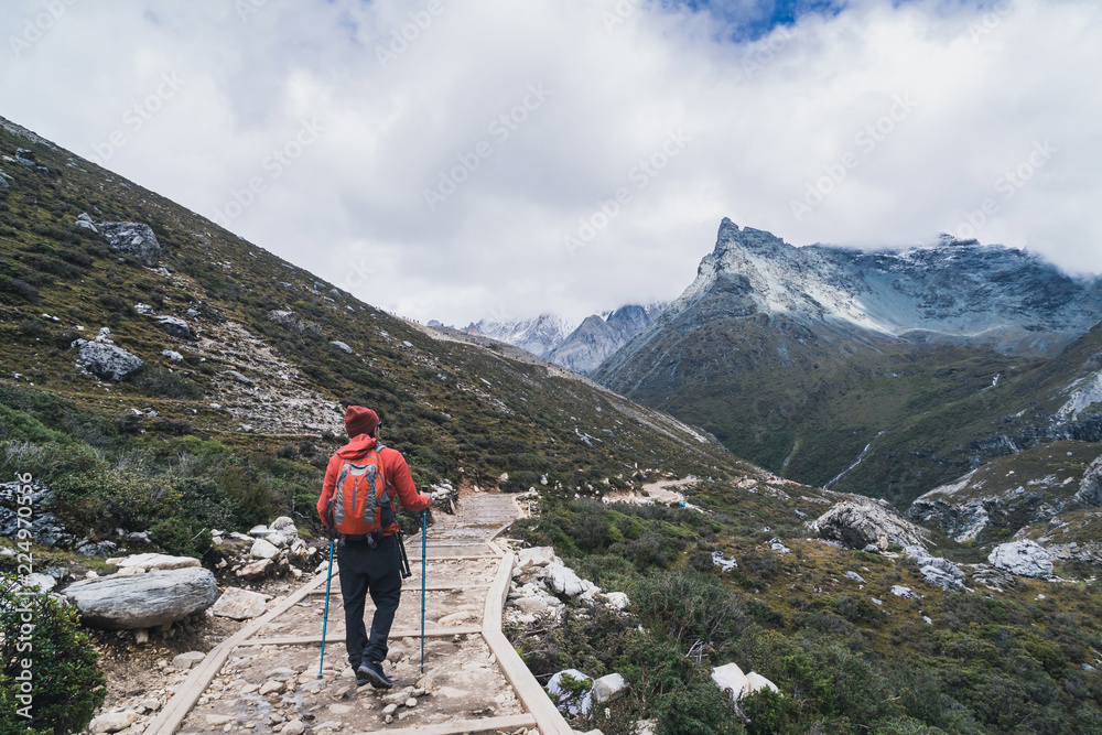 Hiking young traveler with backpack looking beautiful landscape, Travel lifestyle concept