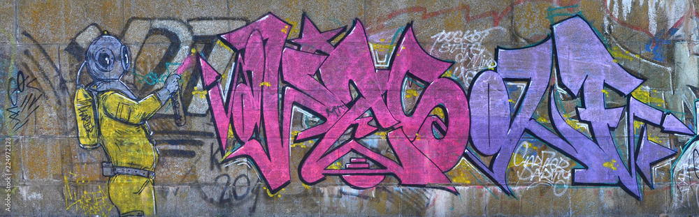 Fototapeta premium Fragment of graffiti drawings. The old wall decorated with paint stains in the style of street art culture. Scary scuba diver