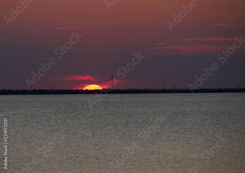 The sun halfway gone in in the horizon © raksyBH