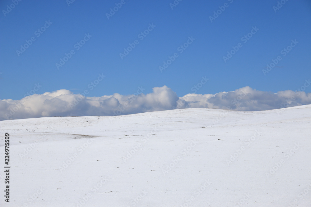 Fototapeta premium winter landscape. Snow slope, horizon, clouds