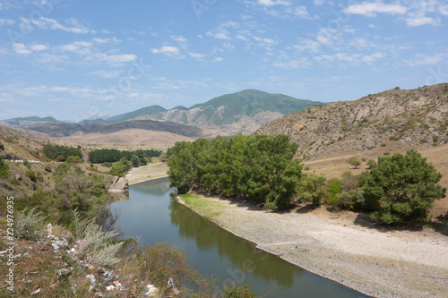 The upper reaches of the river Mtkvari. River polluted with household waste photo