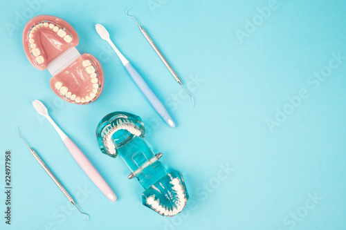 dentist tools and orthodontic on the  blue background, flat lay, top view. photo