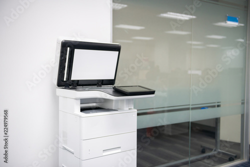 White modern laser multi function printer in the office location