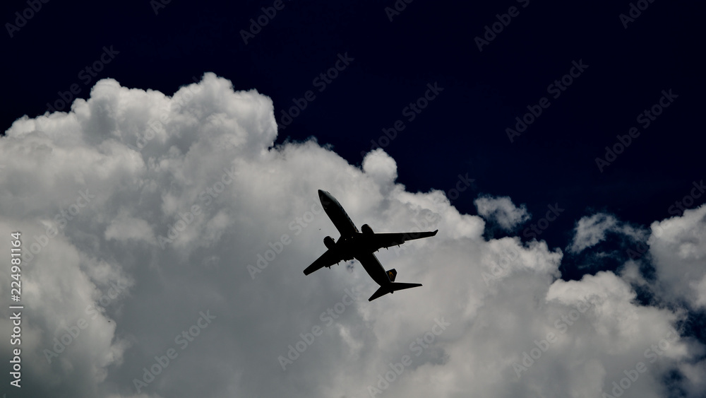 Low angle view airplane against clouds Low angle view airplane against clouds