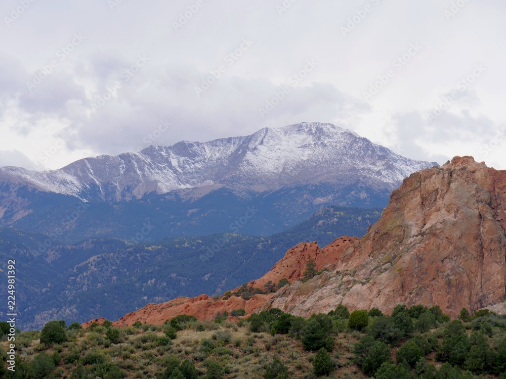 Close up of some of the stone formations at the Garden of the Gods and snow-capped Pikes Peak in the background 