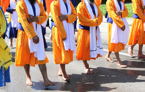 many sikh men without shoes on the road