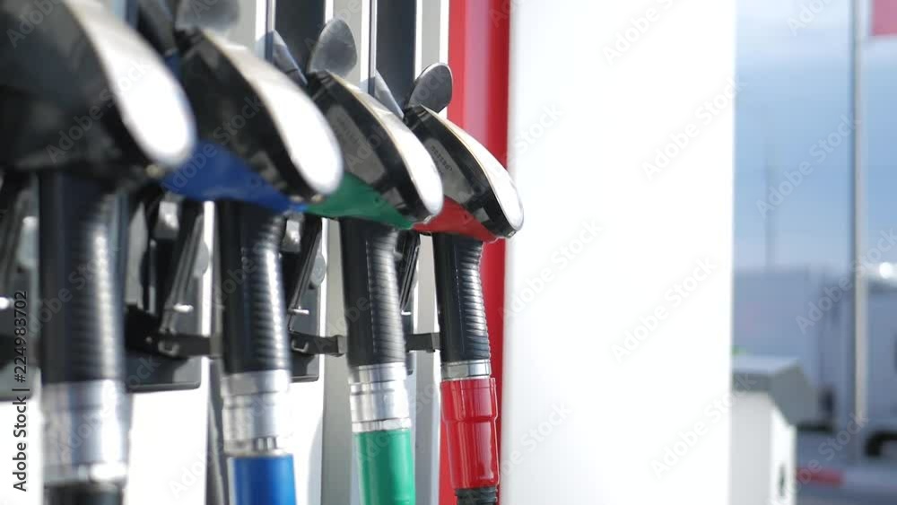Close up of petroleum gasoline station service - oil refueling and refilling for car transportation concept. Gas station, Fuel pump, Petrol pump filling nozzles. Close up of petroleum gasoline station service - oil refueling and refilling for car transportation concept. Gas station, Fuel pump, Petrol pump filling nozzles.
