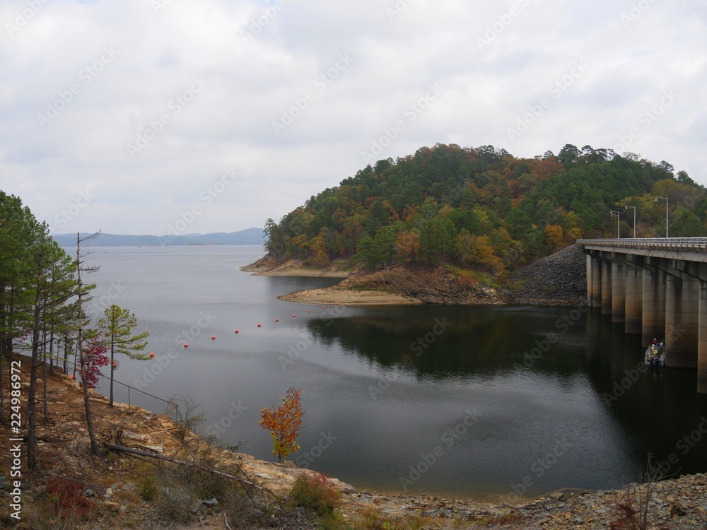 Medium shot of Broken Bow lake with a bridge at the Beaver’s Bend State Park overlook with the colors of autumn Medium shot of Broken Bow lake with a bridge at the Beaver’s Bend State Park overlook with the colors of autumn