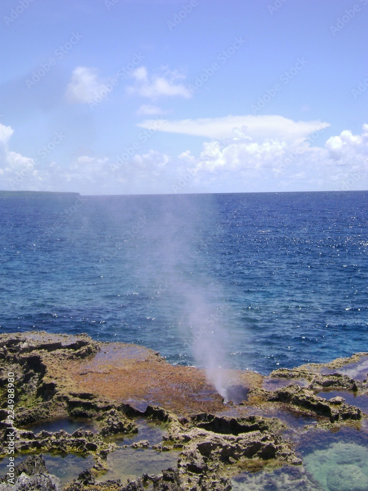 Portrait shot of the famous Blow Hole in the North Field of Tinian, Northern Mariana Islands Portrait shot of the famous Blow Hole in the North Field of Tinian, Northern Mariana Islands