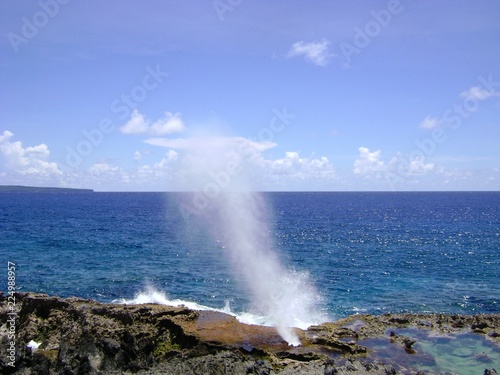 Wide shot of the famous Blow Hole in the North Field of Tinian, Northern Mariana Islands photo