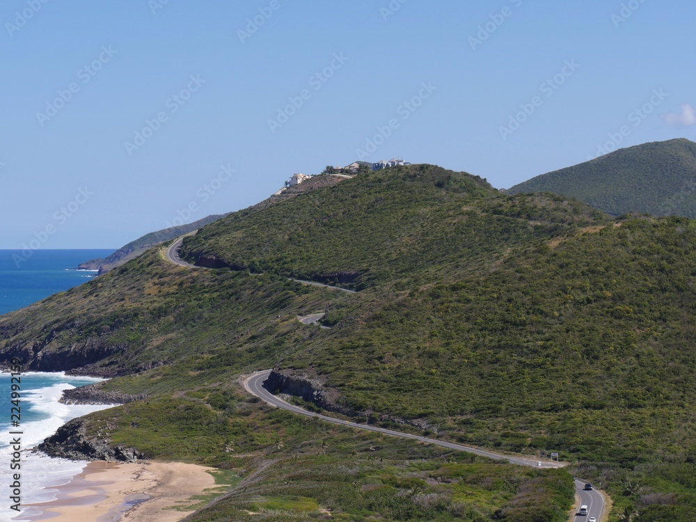 Fototapeta premium Scenic drive along the paved winding roads in the mountainside facing Frigate Bay, St. Kitts, West Indies 