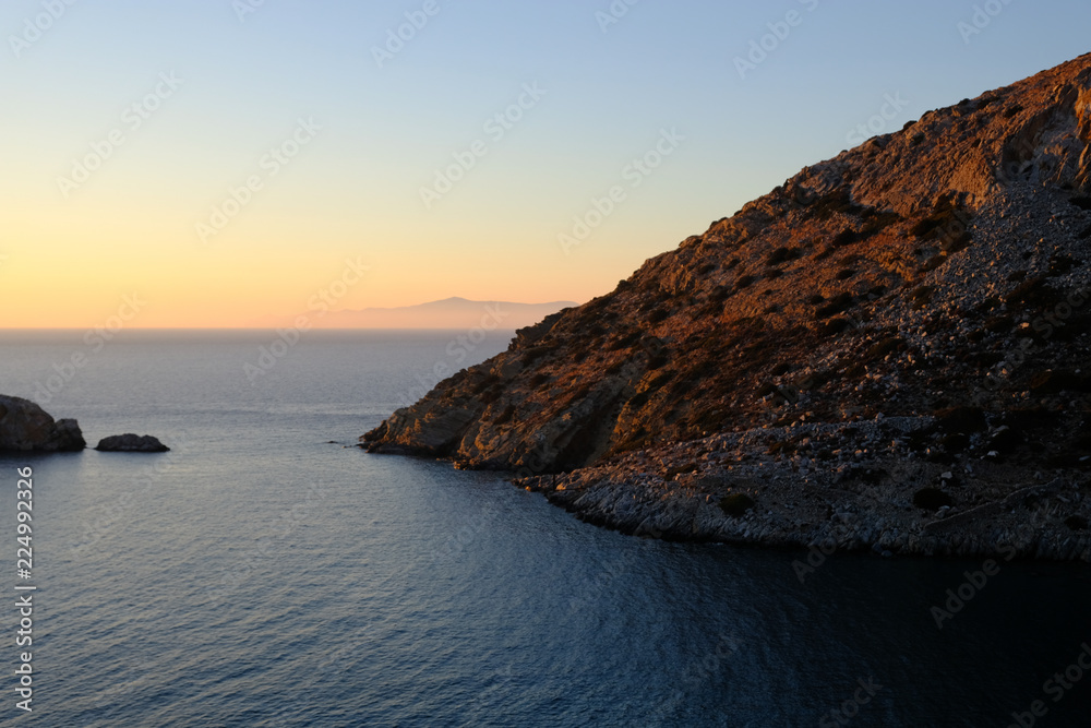 Island of Syros in greece, panorama of cliff close to Varvarousa beach with  sand land and sea. Sunset. Stock Photo | Adobe Stock