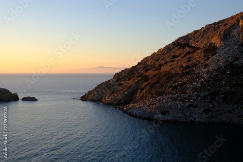 Island of Syros in greece, panorama of  cliff close to Varvarousa beach with sand land and sea. Sunset. photo