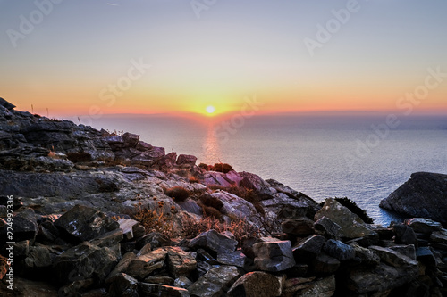 Island of Syros in greece, panorama of  cliff close to Varvarousa beach with sand land and sea. Sunset. © Marco