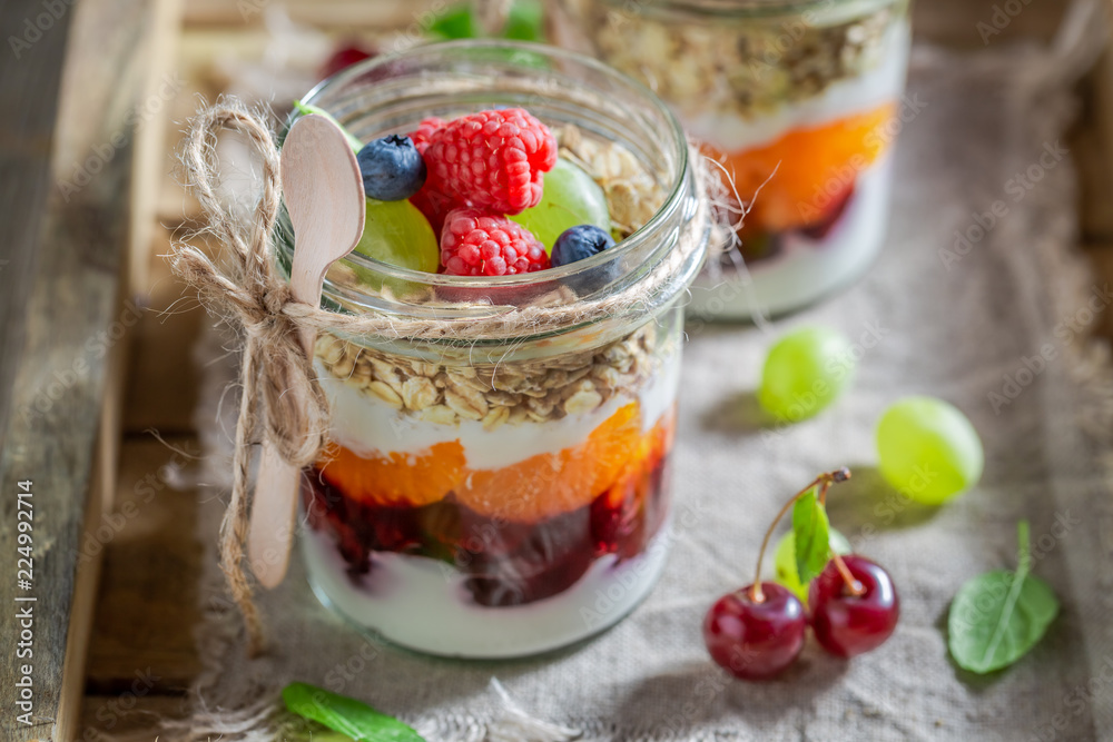 Healthy oat flakes with fresh fruits and yoghurt in jar Healthy oat flakes with fresh fruits and yoghurt in jar